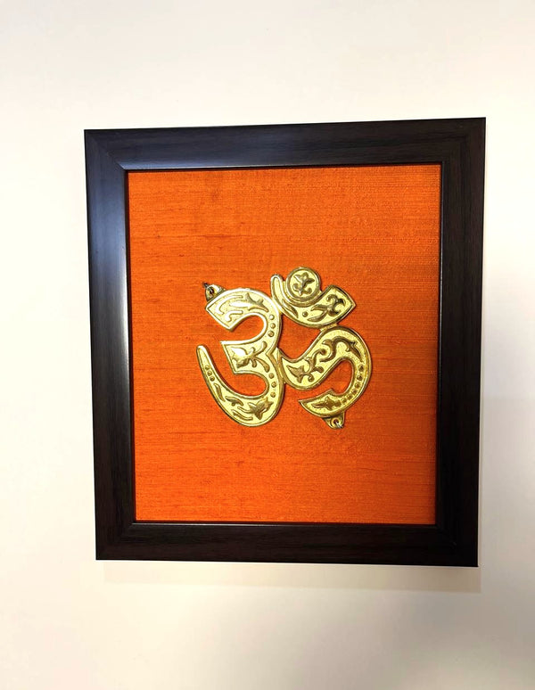 Aum Auspicious Symbol Pure Raw Silk Brass Wall Décor I Spiritual Symbol Wall Décor I Om Brass Accent on Orange silk backdrop I Brass & Silk Shubh Chinha Wall Frame