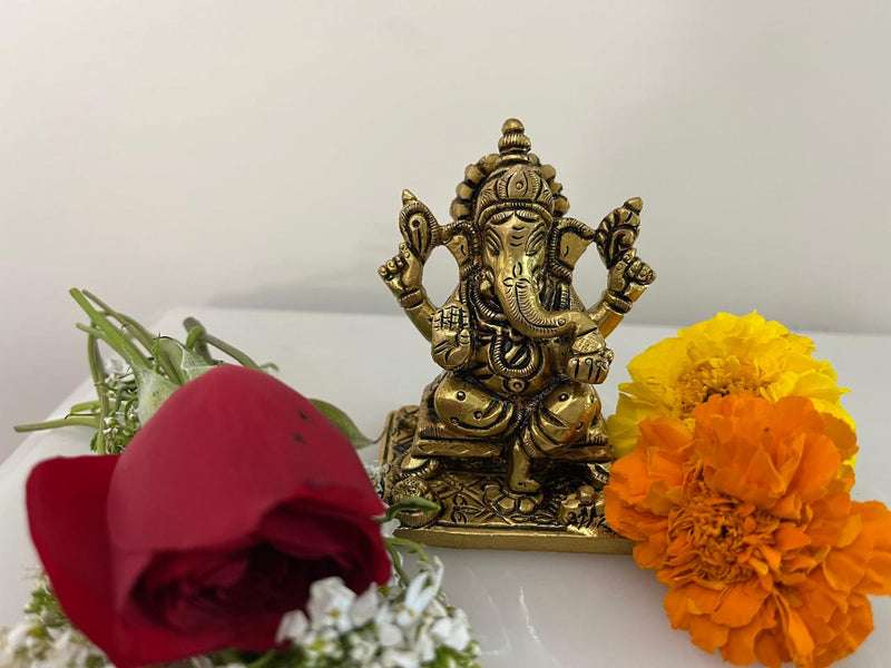 Goddess Lakshmi sitting graciously on a finely carved pedestal with Lotus buds in her two hands symbolizing wealth and prosperity