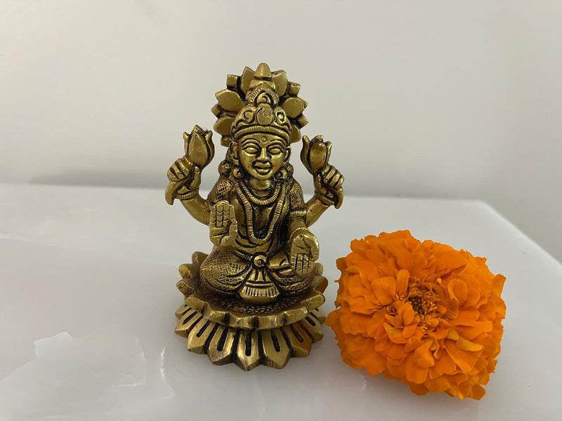 In this exquisitely engraved Brass statues of Goddess Lakshmi &amp; Ganesh ji are seated on fully bloomed Lotus pedestals representing the purity &amp; piousness