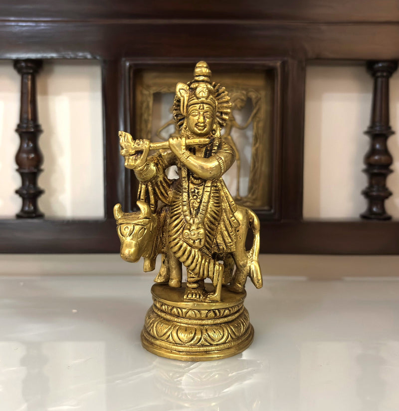 This 4.5” brass idol of&nbsp;Lord Krishna with a cow is a beautiful representation of divinity, love, and harmony