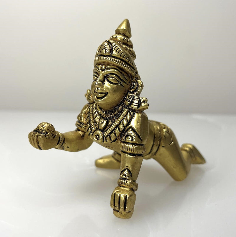 This small Lord Laddu Gopal Brass Statue represents the divine presence of Lord Krishna in his child form