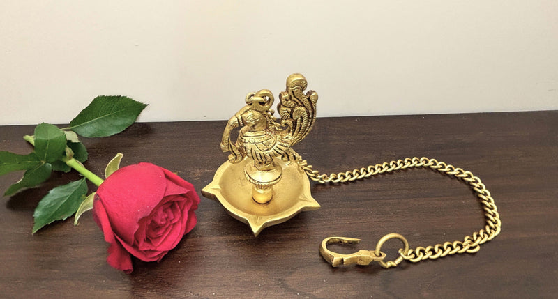 This Diya has an  basin with five wicks and a Annapakshi sitting on top of the lamp as a connector between Diya and the chain.