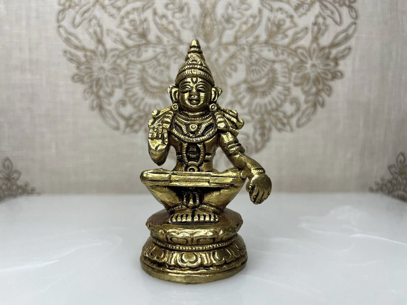 Invite the serene presence of Lord Ayappan with this 2.7-inch statue of Lord Ayyappan in fine brass